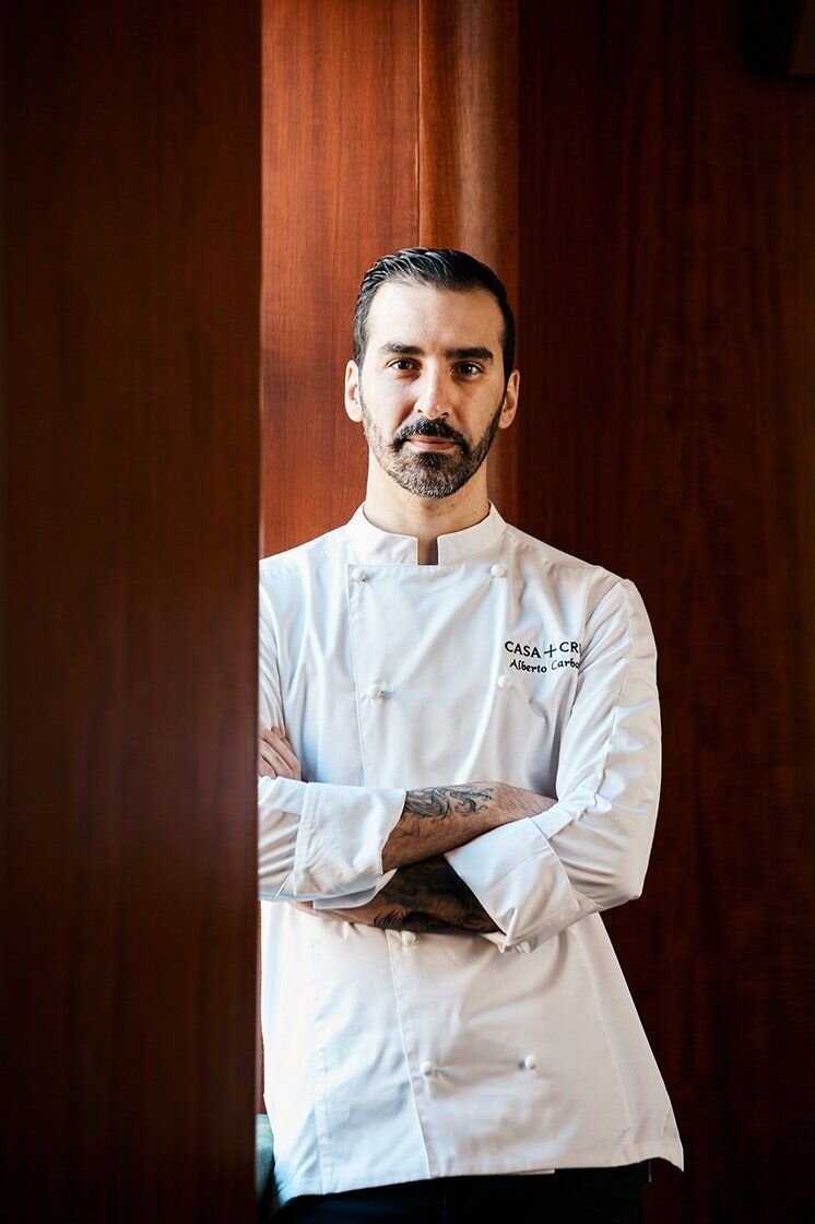 Chef Surjan Singh in a white chef coat with arms crossed
